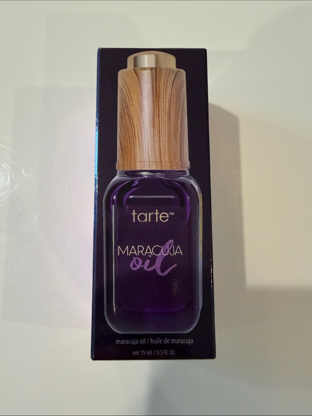 tarte Maracuja Oil Bottle in Deep Purple with Wood-Tone Cap